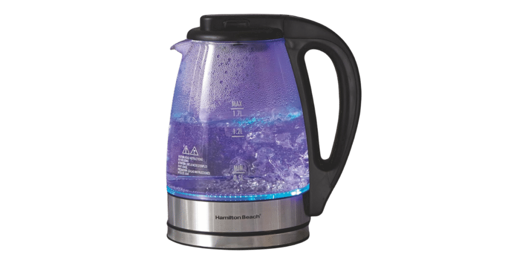 A glowing glass appliance boiling water with blue LED lights.